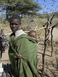 A Datoga woman carries her child